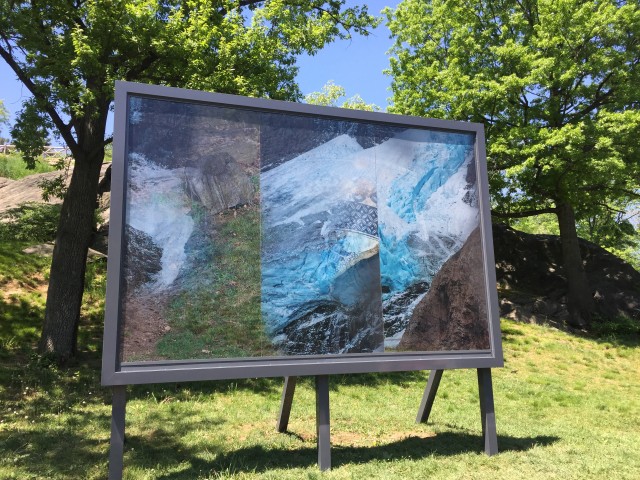 Karyn Oliver 'Here and Now/Glacier, Shar, Rock is a sculptural lenticular billboard adjacent to the Harlem Meer that invokes and blends contrasting topographuc and anthropological histories of Central Park through shifting images of a glacier, a Seneca Village pottery shard, and rocks.